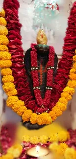 Snake idol with vibrant flowers and garlands, creating a spiritual decor.