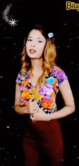 Woman in floral top with starry black background wallpaper.