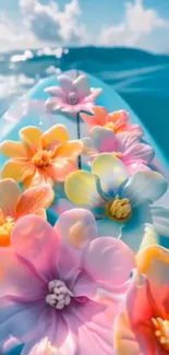 Colorful flowers on a surfboard by the sea.