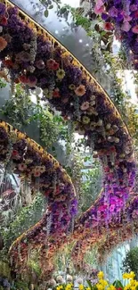 Vibrant floral archway with cascading flowers and greenery in a serene garden setting.