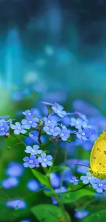 Yellow butterfly resting on blue flowers in lush nature setting.