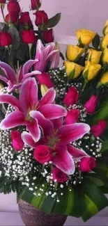 Vibrant bouquet of roses and lilies in a decorative vase.