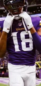 Football player in purple attire focusing passionately on the game field.