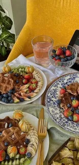 Colorful breakfast spread with waffles and fruit.