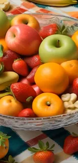 A vibrant fruit bowl filled with apples, oranges, and strawberries.