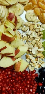 Colorful fruit platter with apples, bananas, grapes, and more.