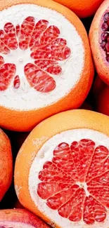 Mobile wallpaper with orange and red fruit slices.