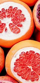 Colorful wallpaper with grapefruit and pomegranate slices.