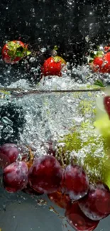 Vivid fruit splash wallpaper showing strawberries, grapes, and kiwi in water.