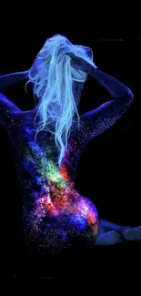 Vibrant galaxy-inspired body art on a figure, glowing against a black background.