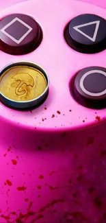 Colorful gaming controller buttons on pink background.