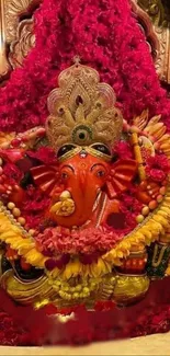 Ganesh idol with vibrant floral decoration on red background.