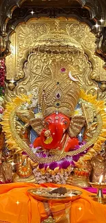 Vibrant Ganesh idol with gold decor and marigold garlands, highlighted in temple setting.