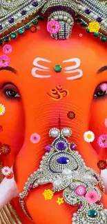 Vibrant orange Ganesha art with intricate decorative details.