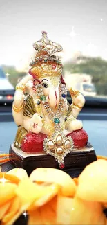 Vibrant Ganesha idol on car dashboard, adorned with jewels.