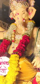 Vibrant Ganesha idol adorned with floral garlands at a festival.