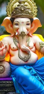 Vibrant Ganesha statue with blue attire in a colorful setting.