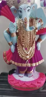 Colorful Lord Ganesha statue with vibrant attire.