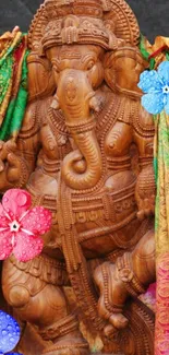 Intricate Ganesha statue with colorful flowers and garments.