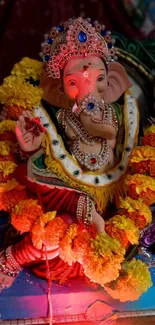 Vibrant Ganesha idol with flowers and intricate decorations.