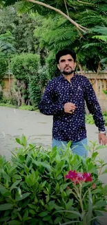 Man strolling in a lush garden with vibrant green plants.