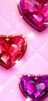 Three vibrant gem hearts on a pink background.