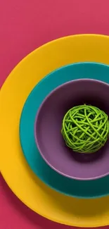 Colorful geometric plate design with a green sphere centerpiece.