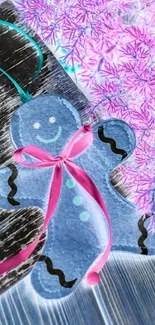 Blue gingerbread ornament with pink ribbon against festive background.