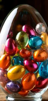 Colorful stones in a glass egg on wooden base.