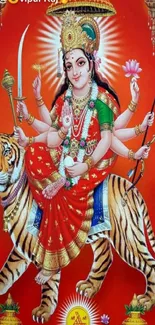 Goddess Durga in red attire with tiger on a vibrant phone wallpaper.