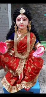 Vibrant goddess idol draped in a red saree, adding cultural elegance.