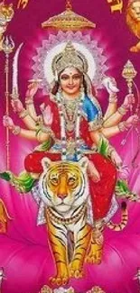 Vibrant Hindu goddess with tiger on pink background wallpaper.