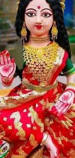 Vibrant goddess in red dress, traditional attire, with gold jewelry.