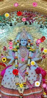 Colorful Hindu goddess with gold ornate background and flowers.