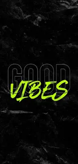 Vibrant neon 'Good Vibes' text on textured black wallpaper.