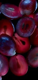 Sliced grapes on a black background wallpaper.