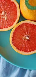 Grapefruit slices on a turquoise plate.