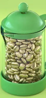 Lime green French press with gold coffee beans displayed inside.