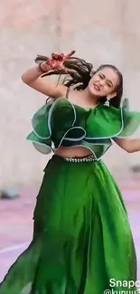 Woman in green dress dancing happily.