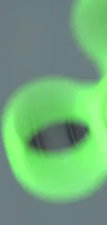 Close-up of a vibrant green fidget spinner in motion.