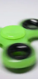 Vibrant green fidget spinner wallpaper for mobile phones.