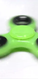 Vibrant green fidget spinner on a white background.