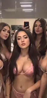 Group of women in bikinis taking a mirror selfie.