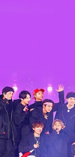 Dynamic group on stage with purple background.