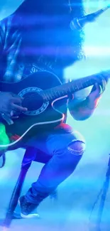 Musician playing guitar on stage, enveloped in blue lighting.