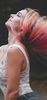 Woman with vibrant flowing pink hair in a natural setting wallpaper.