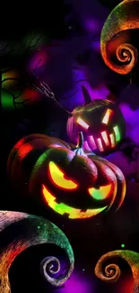 Colorful Halloween pumpkin wallpaper with glowing faces.