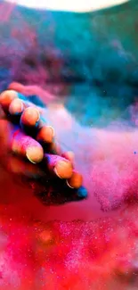 Hand immersed in vibrant colored powder with pink and blue hues.