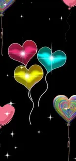 Colorful heart balloons glowing on a black background.