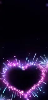 Neon heart-shaped fireworks on dark background.